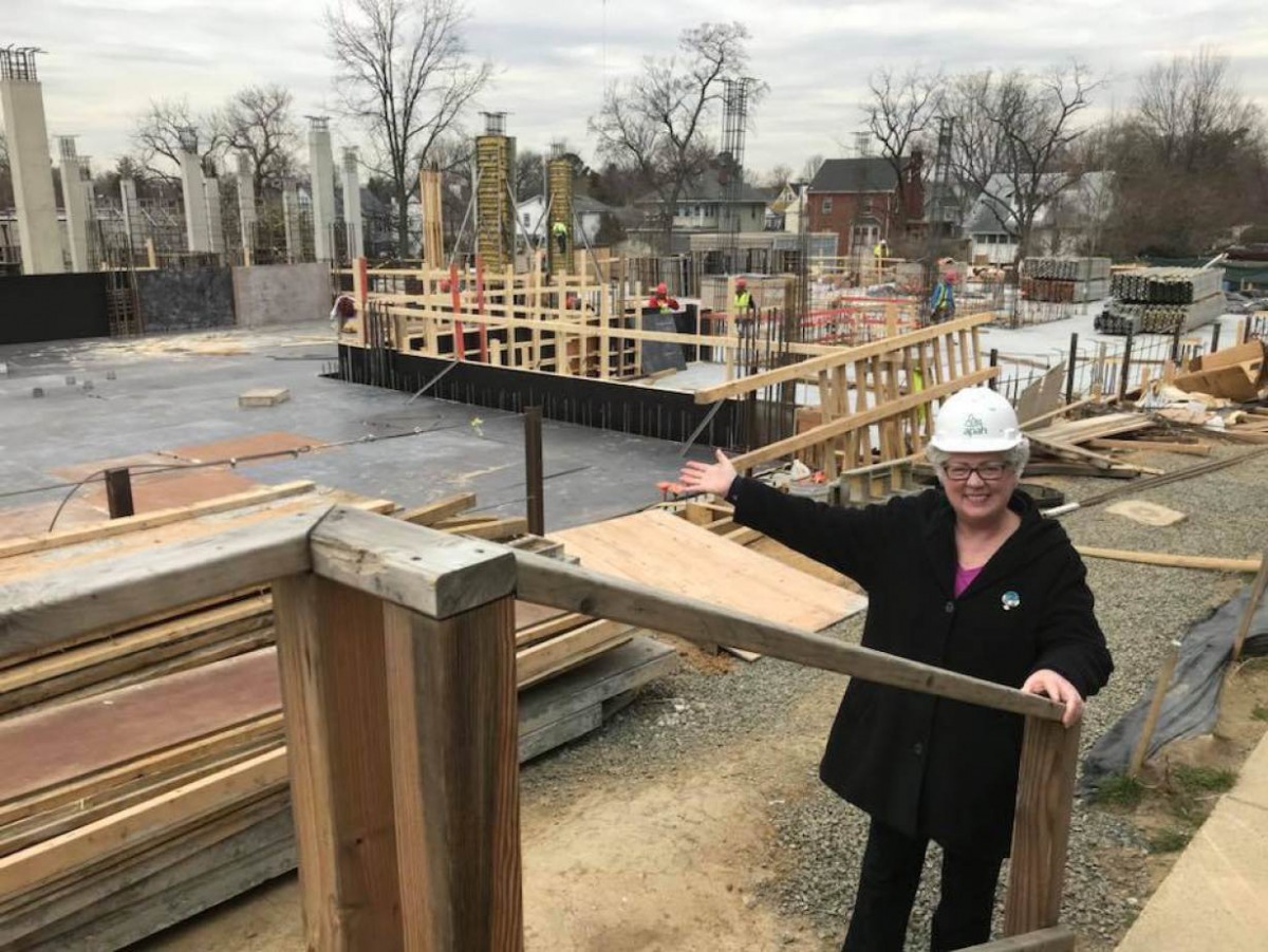 Arlington Presbyterian Church elder Susan Etherton points to the church’s future site as construction proceeds 19 March 2018 on a new affordable housing development in Arlington, Virginia. Handout photo by Susan Etherton