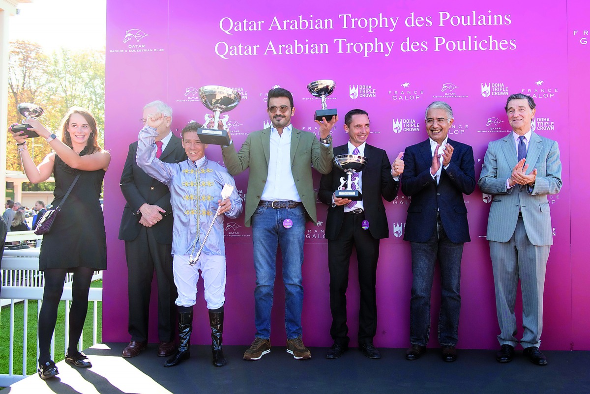 H E Sheikh Joaan bin Hamad Al Thani, President of Qatar Olympic Committee poses for a group picture after races at St Cloud, France yesterday.