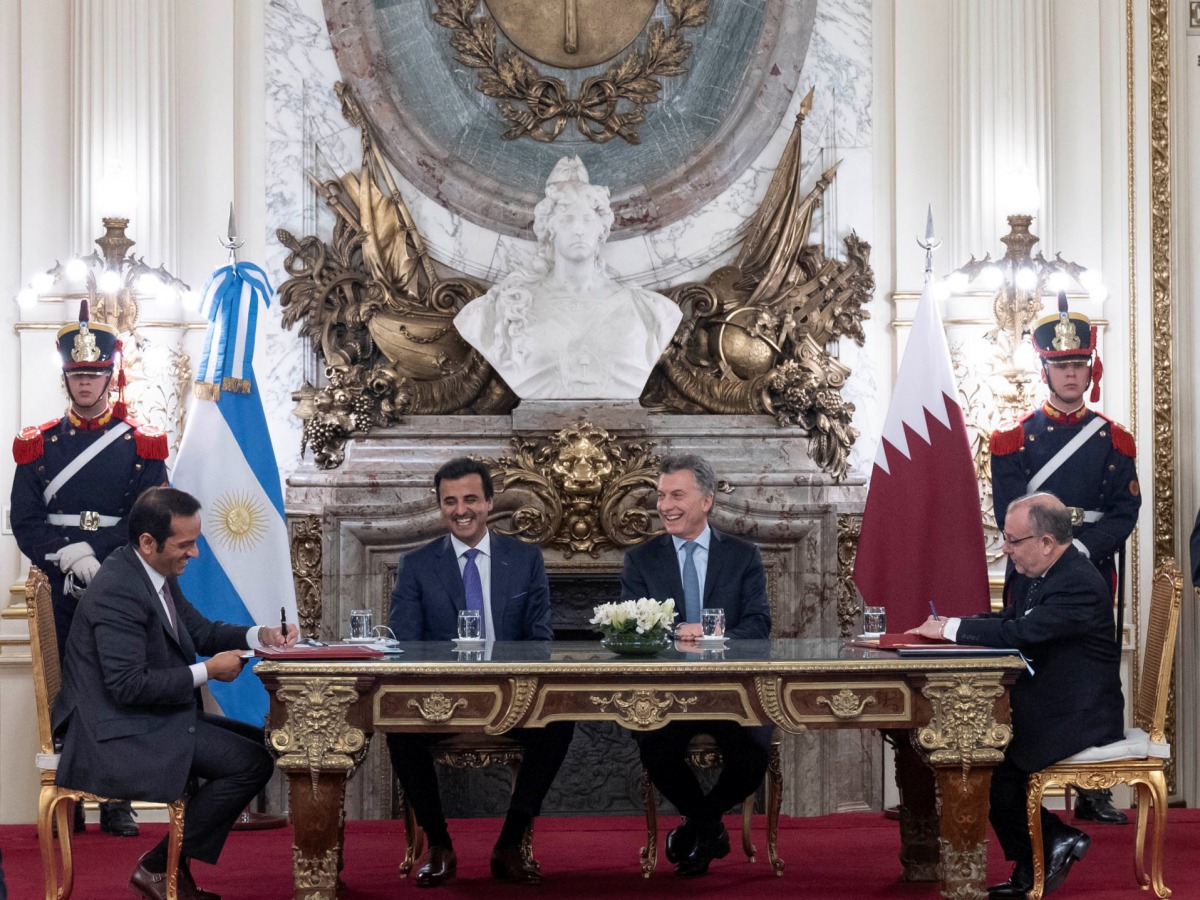 H H the Amir and the President witnessing the signing of an agreement between the two countries.
