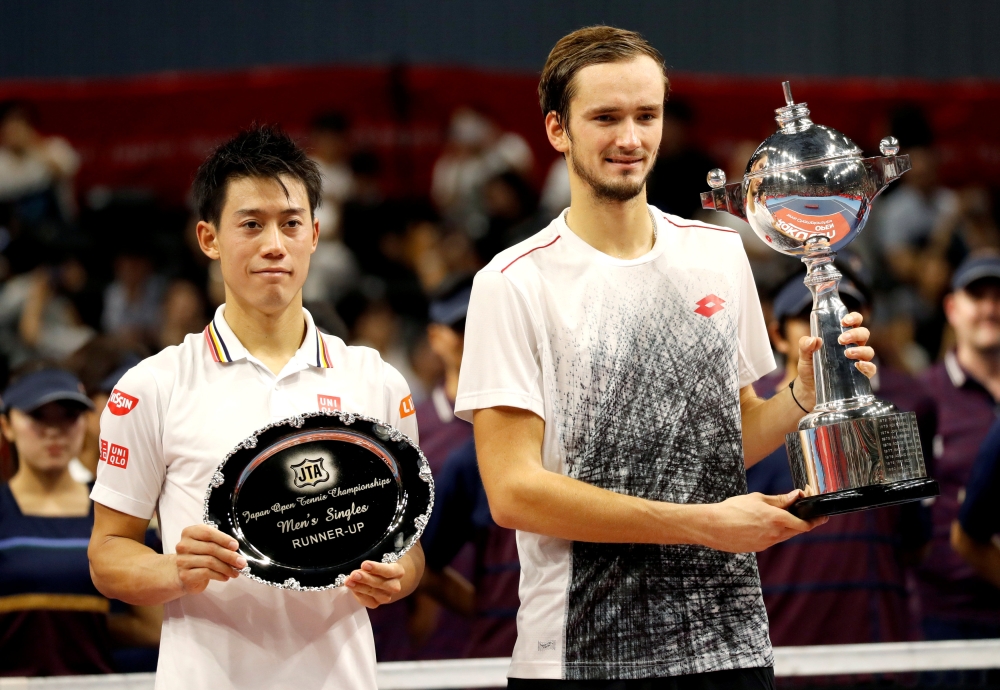 Daniil Medvedev of Russia and Kei Nishikori of Japan pose with their trophies. REUTERS/Kim Kyung-Hoon