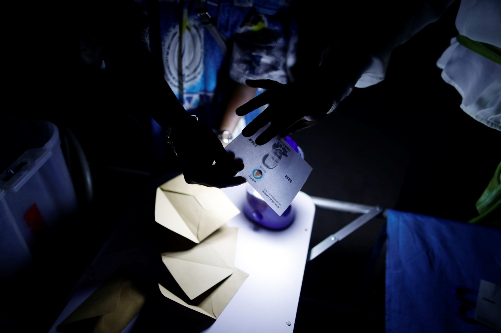 Election workers take part in vote counting during the presidential election in Yaounde, Cameroon October 7, 2018. REUTERS/Zohra Bensemra