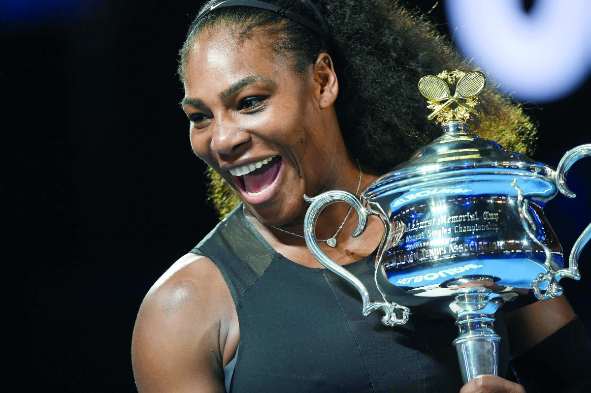 This file photo taken on January 28, 2017 shows Serena Williams of the US holding the winner's trophy following her victory over Venus Williams of the US in the women's singles final of the Australian Open tennis tournament in Melbourne.  AFP / Paul Crock