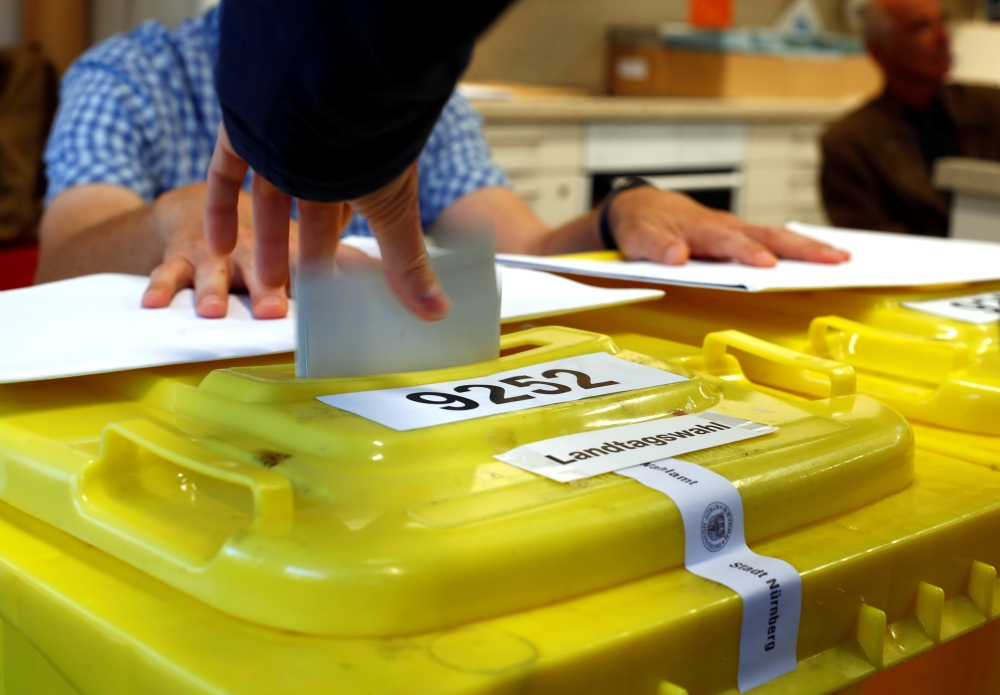 A man casts his vote for the Bavarian state election in Nuremberg, Germany, October 14, 2018. REUTERS/Wolfgang Rattay