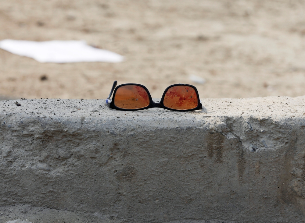 FILE PHOTO: A pair of sunglass with blood is seen at the site of a suicide bomb attack near a mosque in Kabul, March 9, 2018. Reuters/Omar Sobhani
