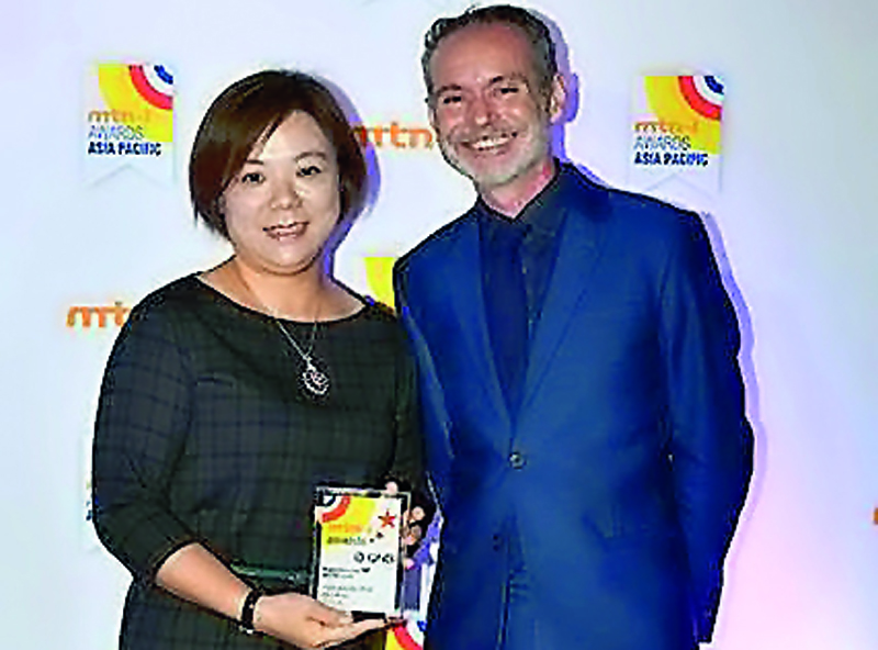 A QNB official with the award.