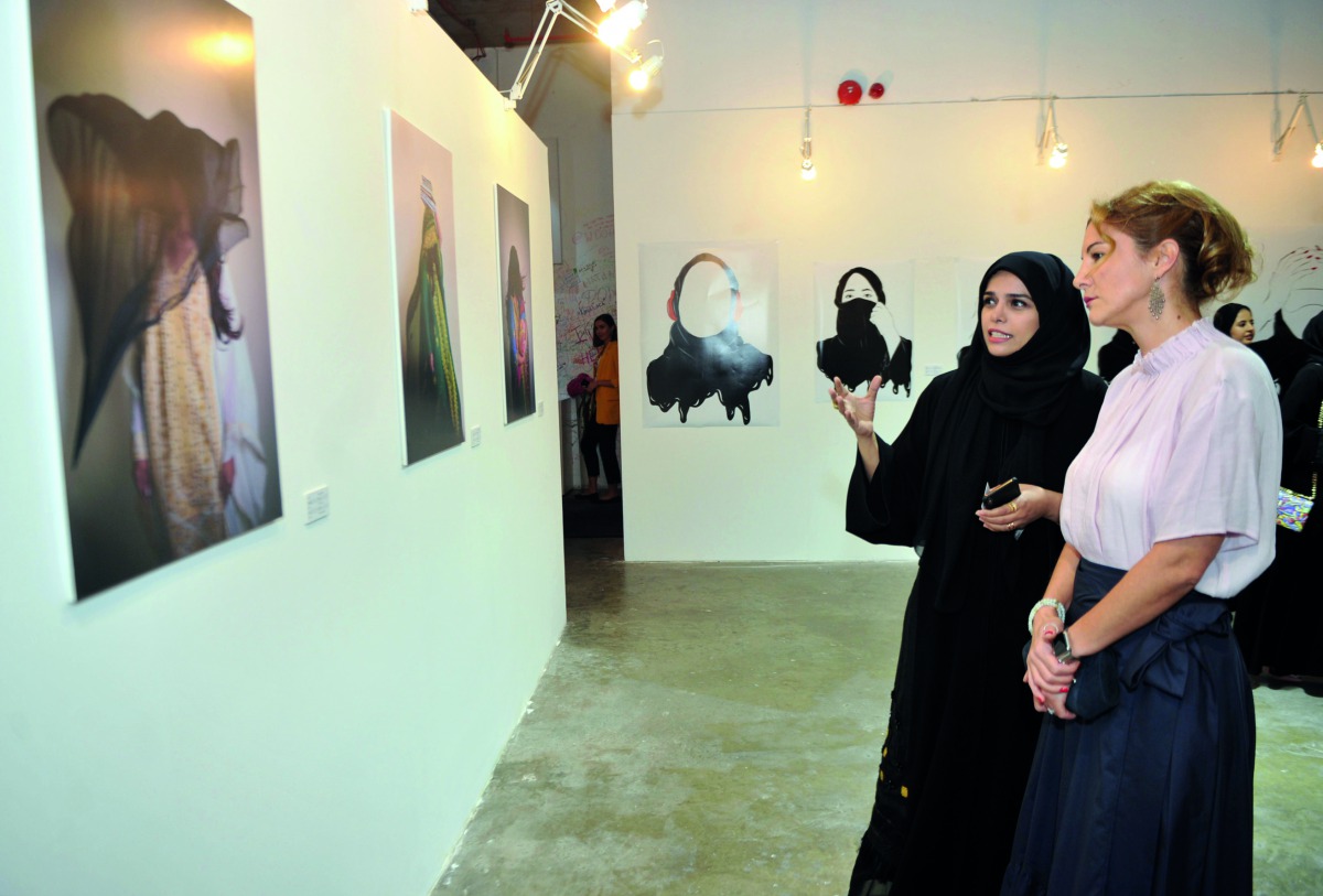 Qatari artist Abeer Al Kuwari (left) explains her works on show at ‘Feminism is a Voice’ exhibition which was launched at Art 29 at W Doha Hotel on Saturday. Pic: Abdul Basit / the peninsula