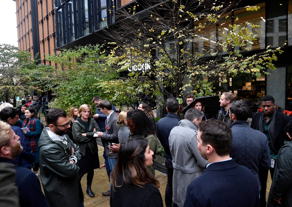 Workers stand outside the Google offices after walking out as part of a global protest over workplace issues, in London, Britain, November 1, 2018. REUTERS/Toby Melville