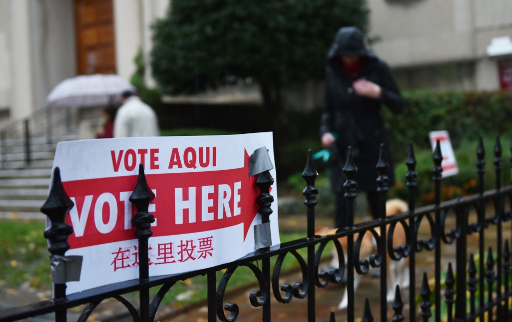 A sign announcing the location of a polling station is seen outside a church in Washington, DC on November 6, 2018. Americans started voting Tuesday in critical midterm elections that mark the first major voter test of Donald Trump's presidency, with cont