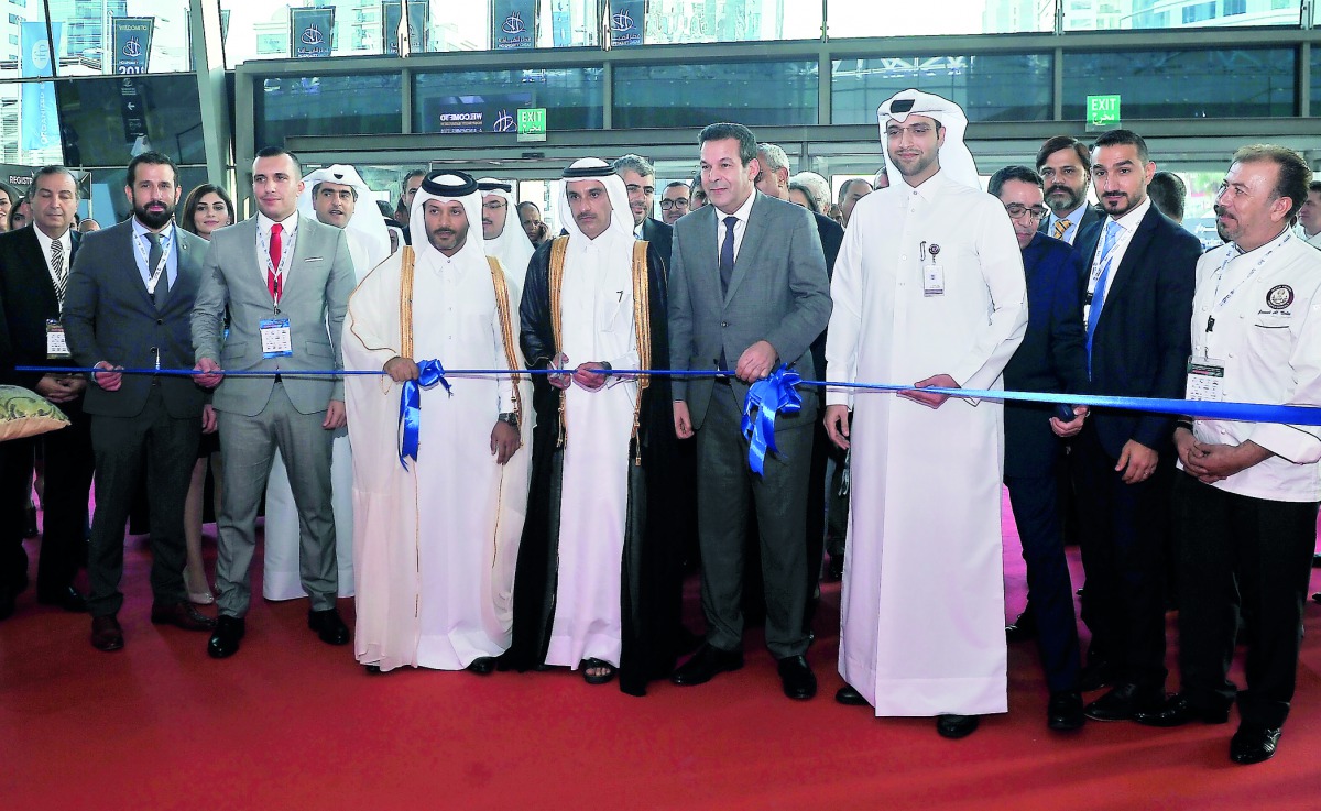Sheikh Nawaf bin Jassim bin Jabor Al Thani, Chairman of the Board of Directors of Katara Hospitality, cutting the ribbon with Said Djellab, Minister of Trade of Algeria, and other officials at the opening of Hospitality Qatar 2018 at DECC yesterday. Pic: 