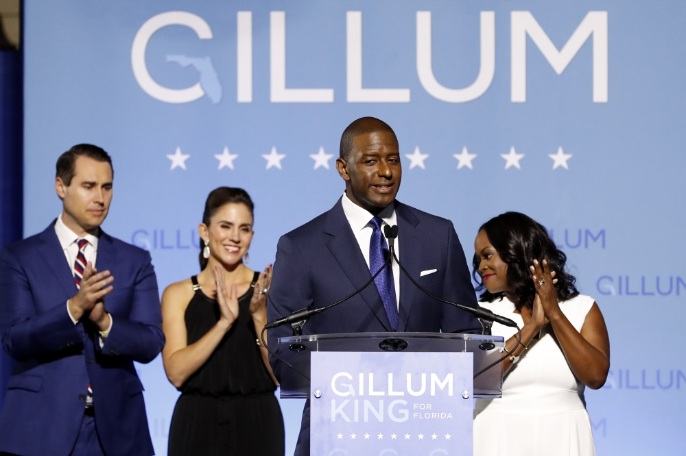 Democratic Florida gubernatorial nominee and Tallahassee Mayor Andrew Gillum concedes the race to U.S. Rep. Ron DeSantis as Gillum's running mate Chris King (L), King's wife Kristin and Gillum's wife R. Jai (R) watch at his side during his midterm electio
