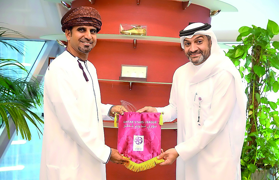 Qatar Stars League (QSL) CEO Hani Taleb Ballan presenting a souvenir to Oman Professional League (OPL) Director Hisham Al Adwani during their meeting yesterday. 