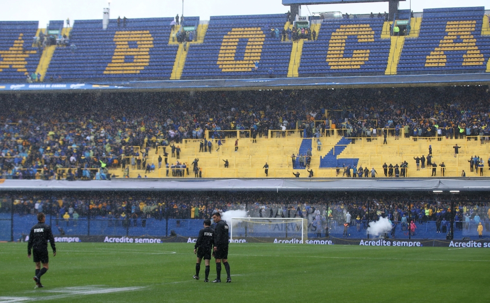 The referee and assistant referee before the match was postponed REUTERS/Agustin Marcarian
