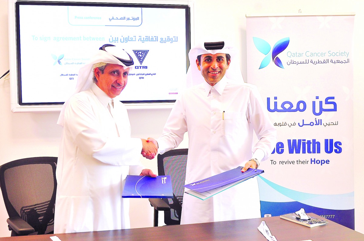 Dr Sheikh Khalid bin Jabor Al Thani, Chairman of QCS (left) and Dr Nasser Saqer Al Mohannadi, Founding President of  Qatar Triathlon Club exchanging documents after signing the MoU yesterday.  
Pic: Baher Amin / The Peninsula