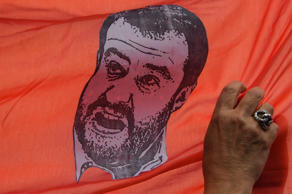 A drawing of Italy’s Interior Minister and deputy PM Matteo Salvini is displayed on a banner during a march as part of the International Day for the Elimination of Violence against Women, on November 24, 2018 in Rome. AFP / Tiziana Fabi 
