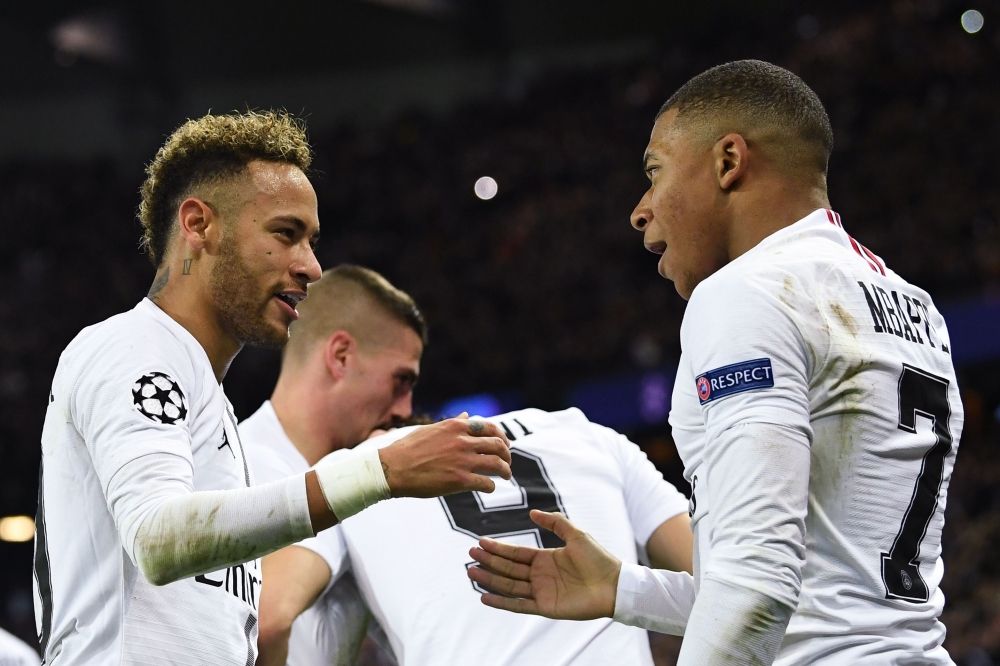 Paris Saint-Germain's Brazilian forward Neymar (L) celebrates with Paris Saint-Germain's French forward Kylian Mbappe (R) after scoring a goal during the UEFA Champions League Group C football match between Paris Saint-Germain (PSG) and Liverpool FC at th