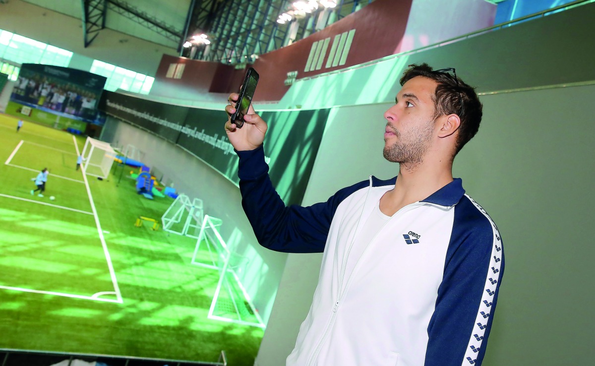 South African Olympic champion Chad Le Clos taking a photograph of the Aspire facilities. 