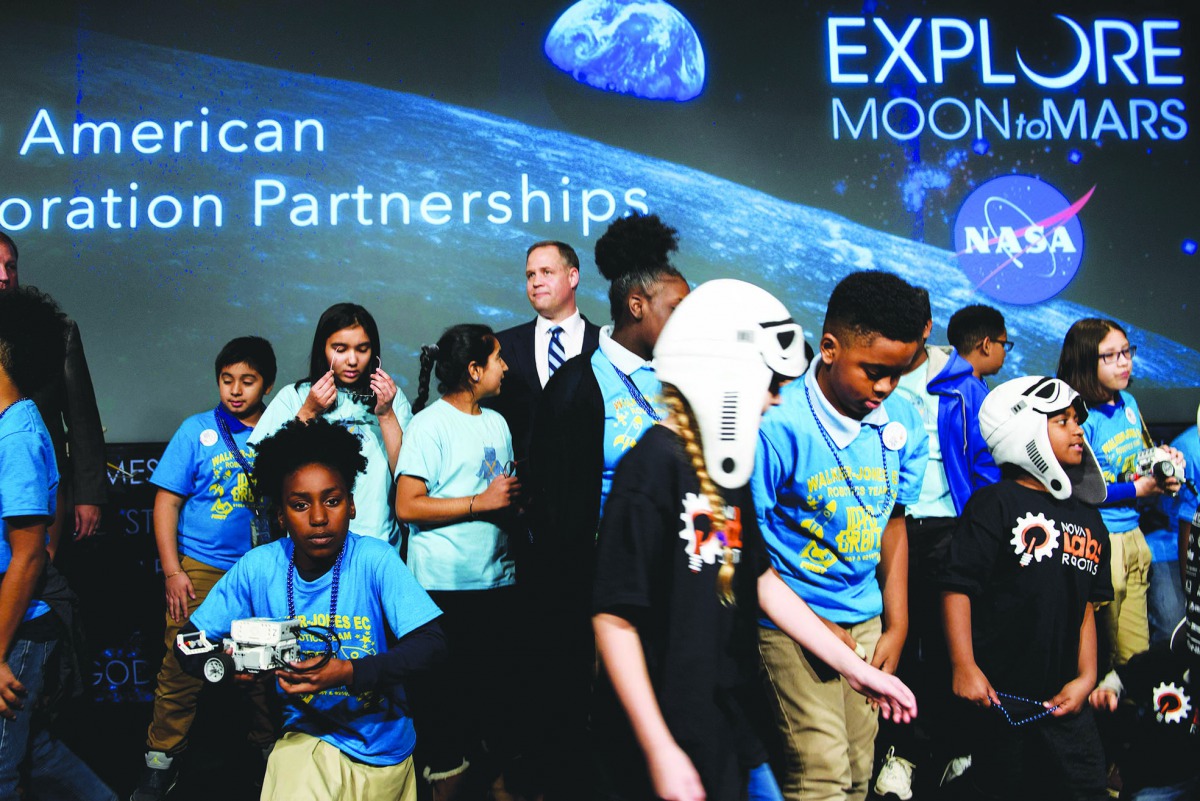 NASA Administrator Jim Bridenstine waits after posing for a photo with students during an event at NASA headquarters November 29, 2018 in Washington, DC.  AFP / Brendan Smialowski

