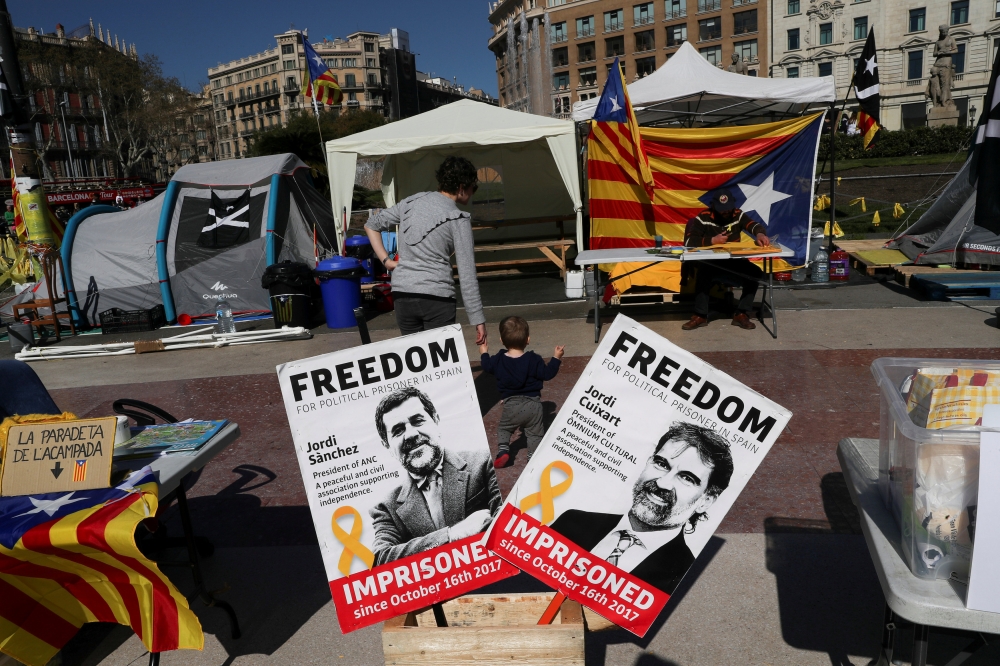 FILE PHOTO: Banners with the photos of jailed Catalan pro-independence leaders Jordi Sanchez and Jordi Cuixart are displayed at a protest rally in Barcelona, Spain March 28, 2018. REUTERS/Susana Vera