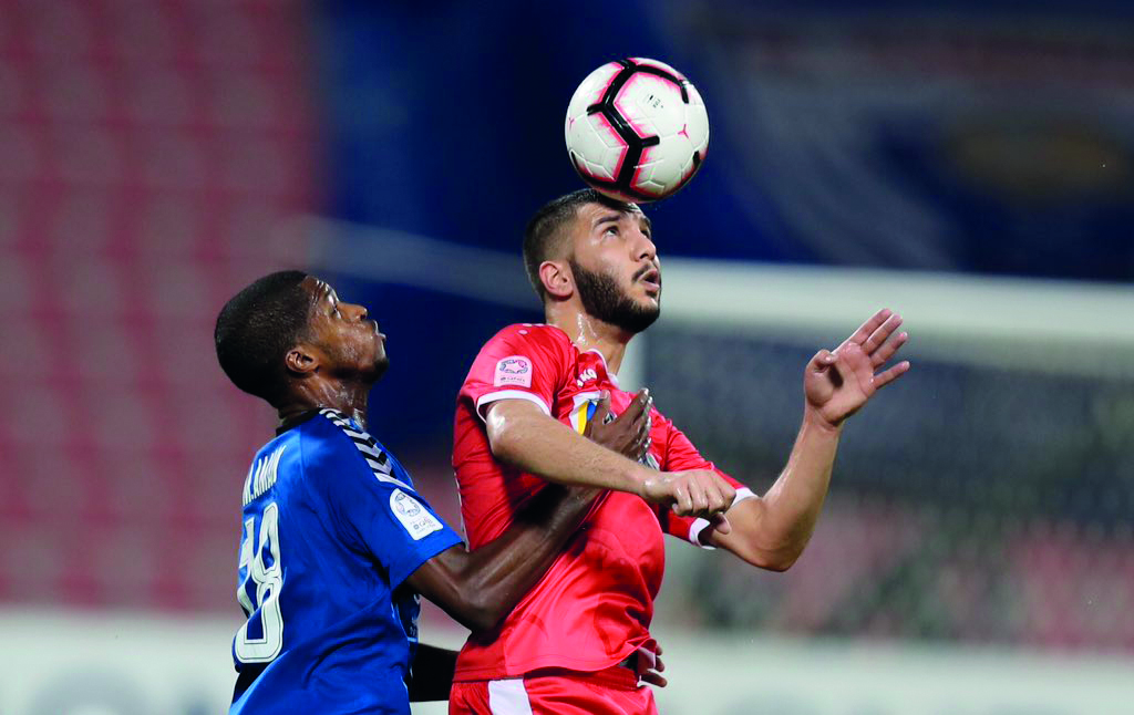 Al Arabi and Al Kharaitiyat players vie for ball possession during their QNB Stars League Round-14 match played at the Al Arabi Stadium yesterday.