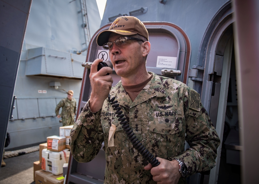 Vice Admiral Scott Stearney, commander of US Naval Forces Central Command, US 5th Fleet and Combined Maritime Forces, speaks on the 1MC shipboard intercom to welcome the crew of the guided-missile destroyer USS Jason Dunham to Manama, Bahrain October 24, 