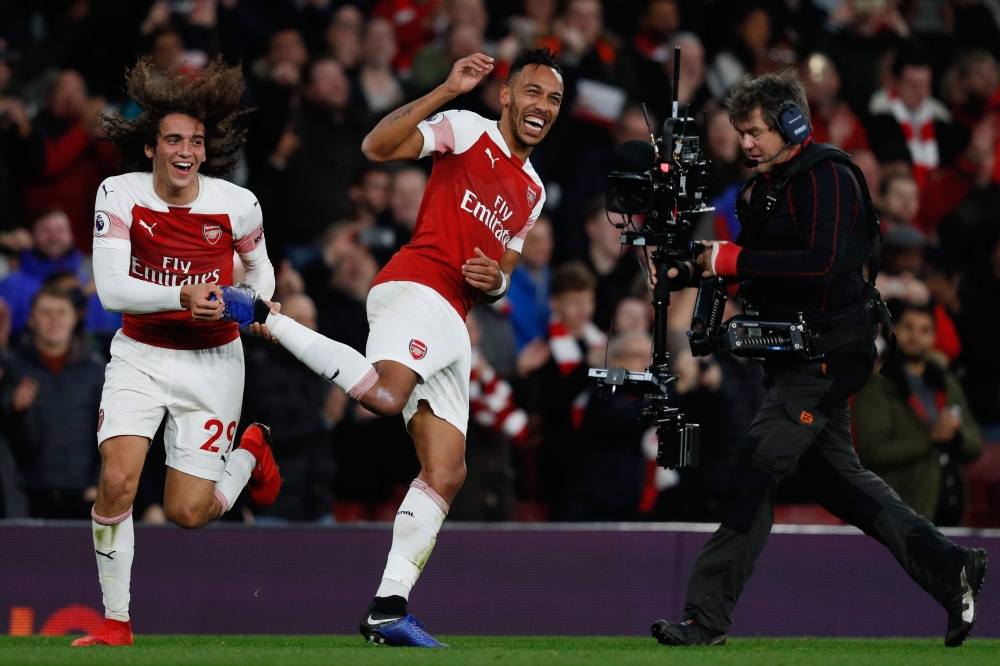 Arsenal's Gabonese striker Pierre-Emerick Aubameyang (R) celebrates with Arsenal's French midfielder Matteo Guendouzi (L) after the English Premier League football match between Arsenal and Tottenham Hotspur at the Emirates Stadium in London on December 2