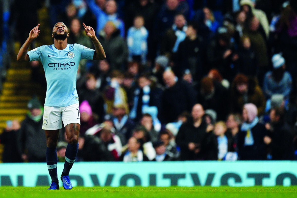Manchester City's English midfielder Raheem Sterling celebrates scoring their second goal for 2-1 during the English Premier League football match between Manchester City and Bournemouth at the Etihad Stadium in Manchester, north west England, on December