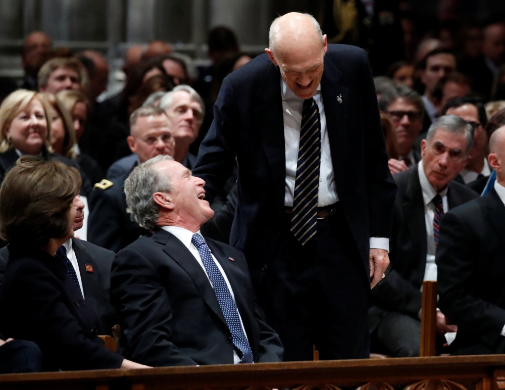 Former Sen. Alan Simpson (R-WY) speaks with former President George Bush as he walks to a podium to speak during the State Funeral for former President George H.W. Bush at the National Cathedral, Wednesday, Dec. 5, 2018, in Washington. Alex Brandon/Pool v