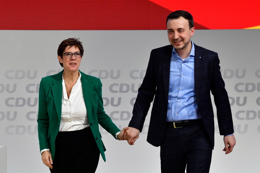 Newly-elected leader of the Germany's conservative Christian Democratic Union (CDU) party Annegret Kramp-Karrenbauer (L) congratulates Paul Ziemiak, leader of Christian Democratic Union (CDU) party's youth organisation (Junge Union) after his speech durin