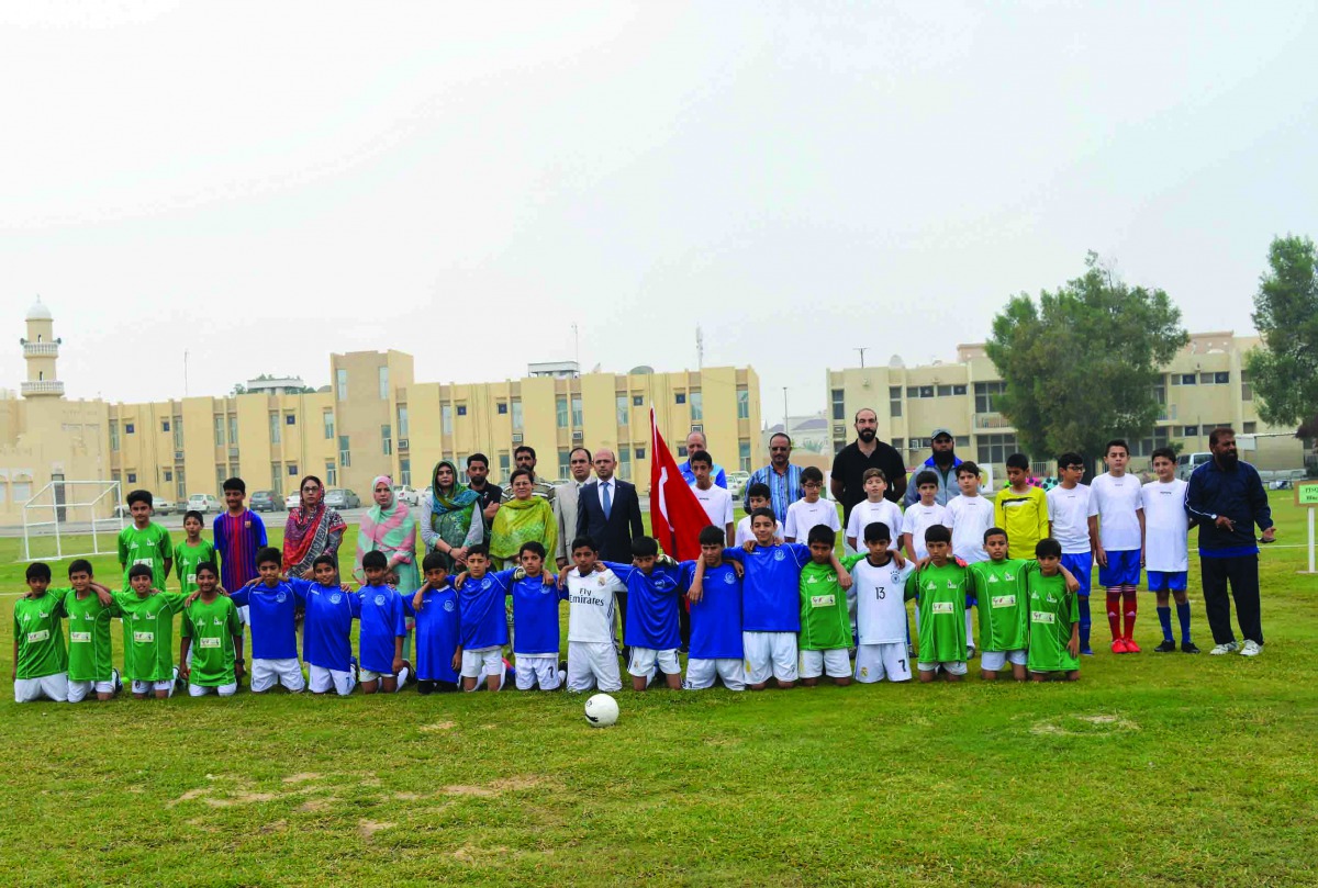 The school officials and team members posing for a group picture.