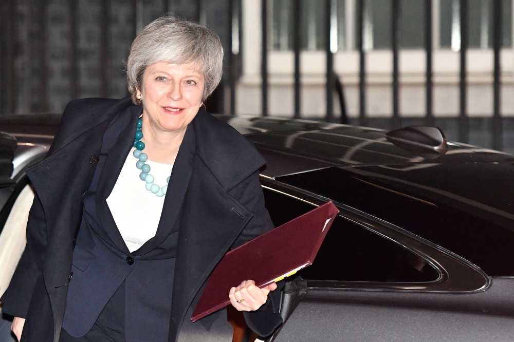 Britain's Prime Minister Theresa May returns to Downing street after postponing a parliamentary vote on her Brexit deal in London on December 10, 2018. / AFP / Ben STANSALL
