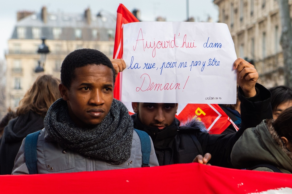 Students hold banners reading 