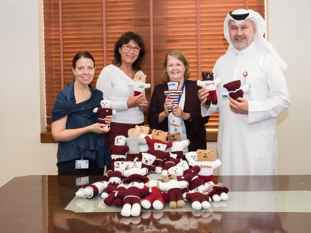 Dr Abdulla Al Ansari, Acting Chief Medical Officer, receives the special knitted teddy bears from representatives of local volunteer groups,  Mary Alkadhi,  Helga Aksam, and Holly Clark, Head of the Child Life Services at HGH.