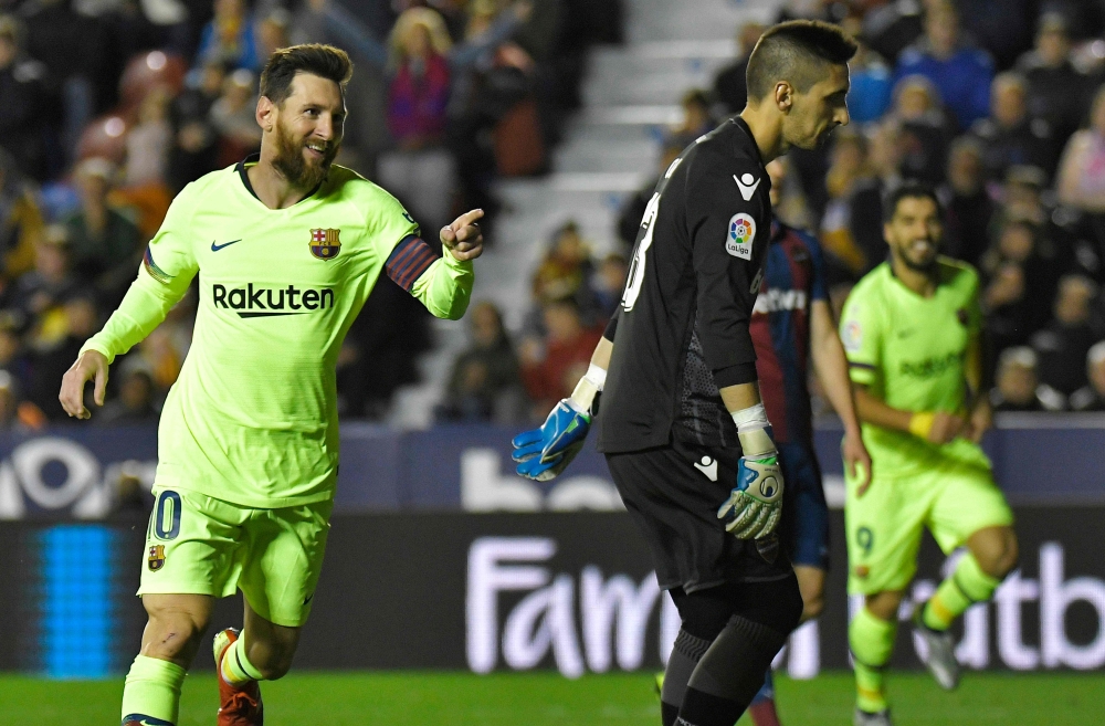 Barcelona's Argentinian forward Lionel Messi celebrates after scoring a goal during the Spanish League football match between Levante and Barcelona at the Ciutat de Valencia stadium in Valencia on December 16, 2018. / AFP / JOSE JORDAN 