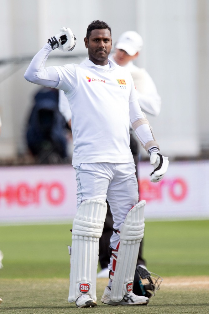 Sri Lanka's batsman Angelo Mathews celebrates reaching his century (100 runs) during day four of the first Test cricket match between New Zealand and Sri Lanka at the Basin Reserve in Wellington on December 18, 2018. AFP / Marty Melville
