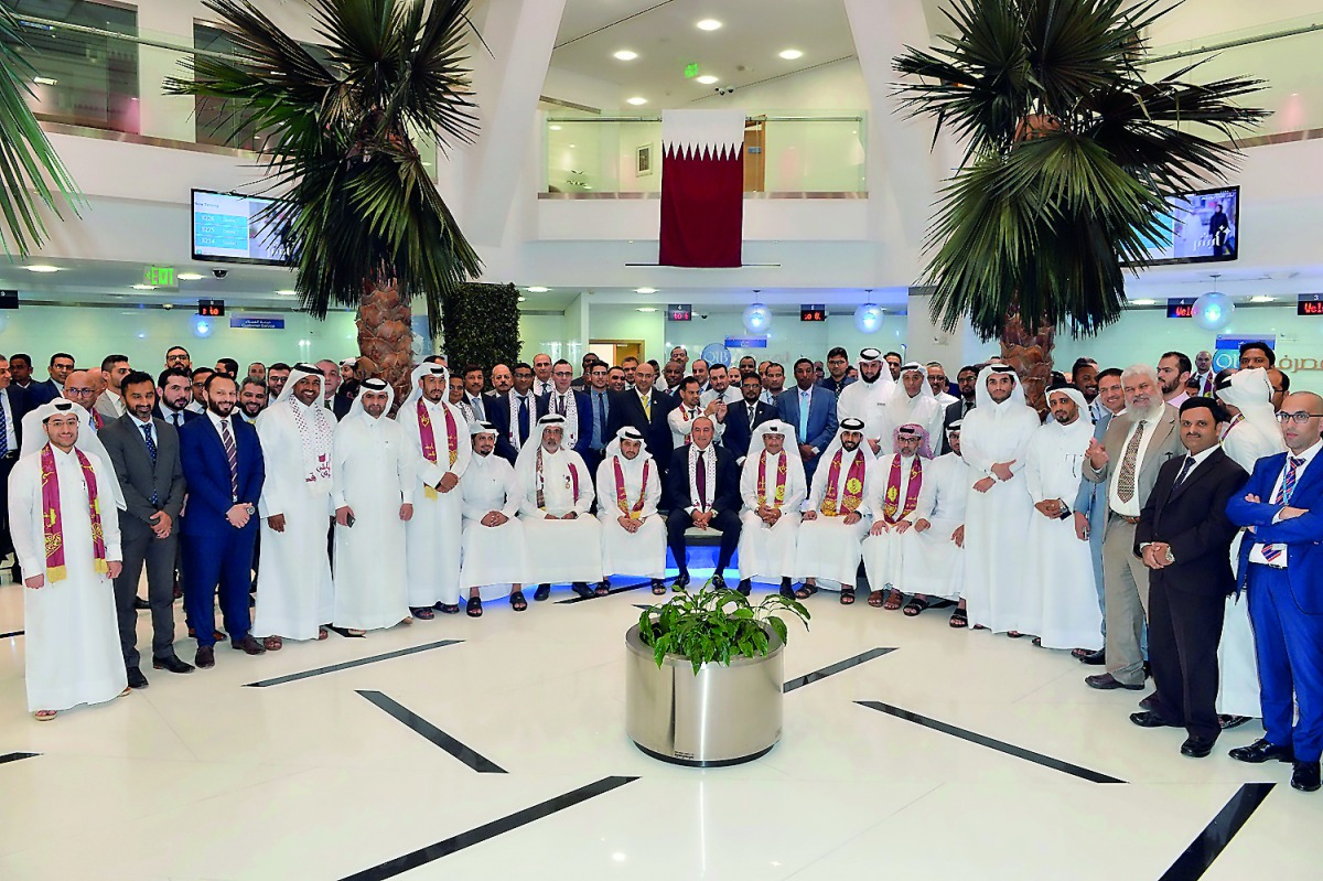 QIB executive management and employees celebrating Qatar National Day, at QIB headquarters located at Grand Hamad Street in Doha, yesterday.