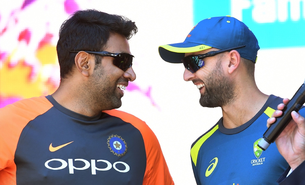 India's spinner Ravichandran Ashwin (L) talks to his Australian counterpart Nathan Lyon during a meet the fans event in Melbourne on December 23, 2018, ahead of their third cricket Test match. AFP / William WEST