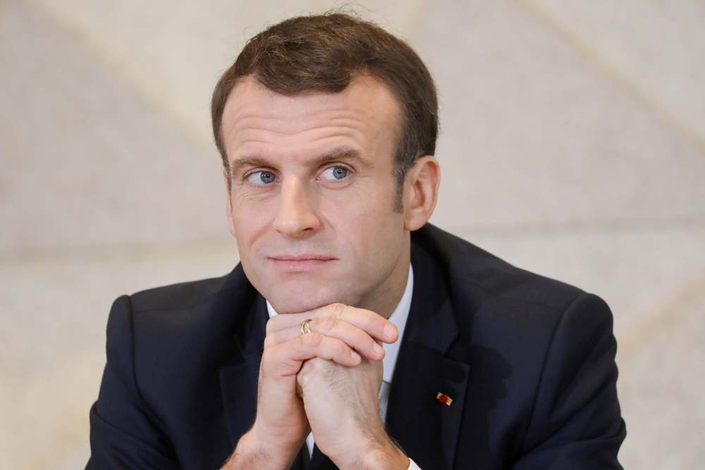 France's President Emmanuel Macron looks on during a meeting with 400 Chad women at the Women Palace in N'Djamena on December 23, 2018 as part of a visit to meet with 'Barkhane' soldiers and the Chadian President. / AFP / Ludovic MARIN