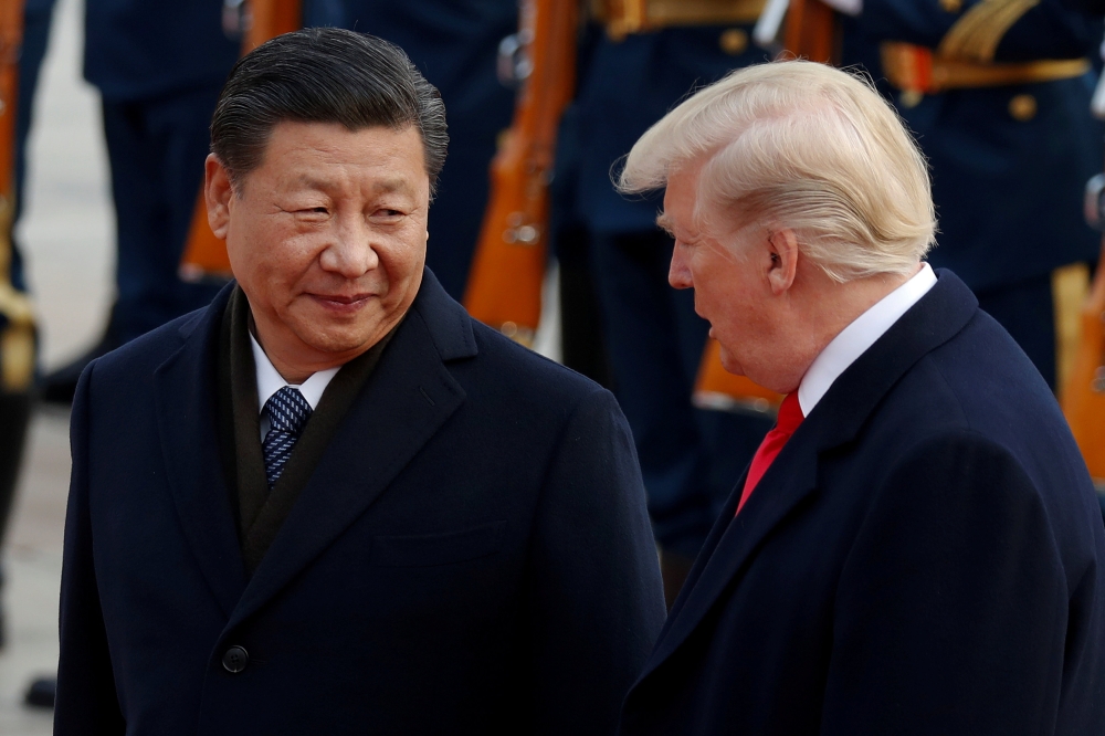 FILE PHOTO: US President Donald Trump takes part in a welcoming ceremony with China's President Xi Jinping at the Great Hall of the People in Beijing, China, November 9, 2017. REUTERS/Damir Sagolj/File Photo