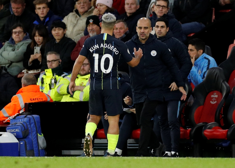 Manchester City's Sergio Aguero shakes hands with manager Pep Guardiola after being substituted. Reuters/John Sibley