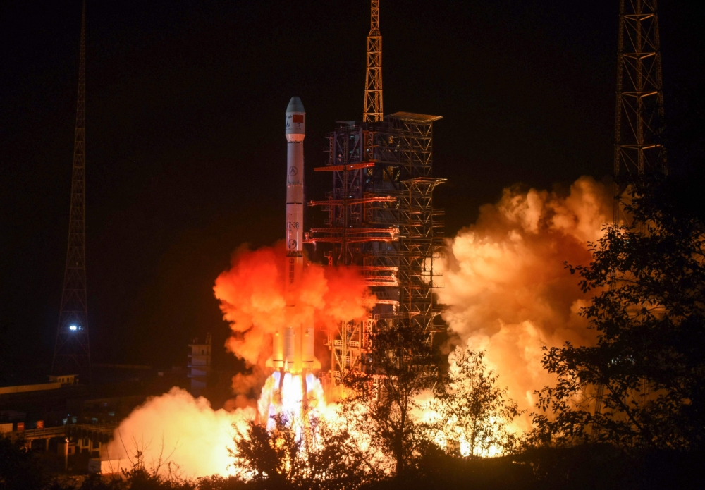 FILE PHOTO: This file picture taken early on December 8, 2018 shows a Long March 3B rocket, transporting the Chang'e-4 lunar rover, lifting off from the Xichang launch centre in Xichang in China's southwestern Sichuan province. AFP / STR