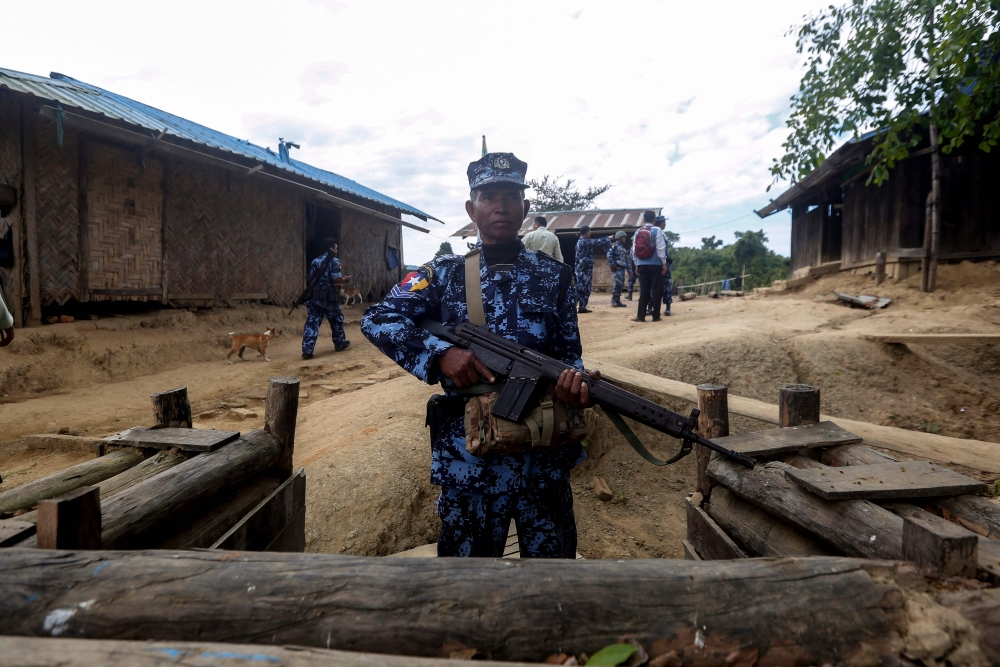 A Myanmar border guard policeman gurads a police station in Buthidaung on January 7, 2019. AFP 