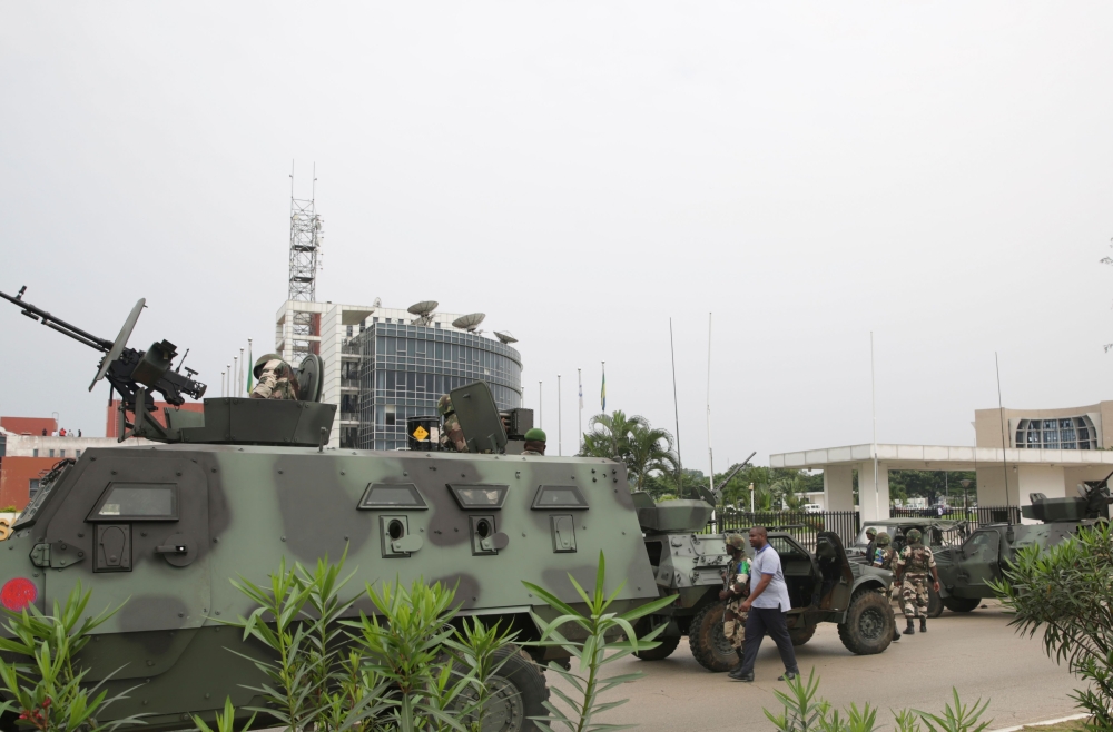 Gabonese soldiers stand in front of the headquarters of the national broadcaster Radiodiffusion Television Gabonaise (RTG) in Libreville on January 7, 2019 after a group of soldiers sought to take power in Gabon while the country's ailing president was ab