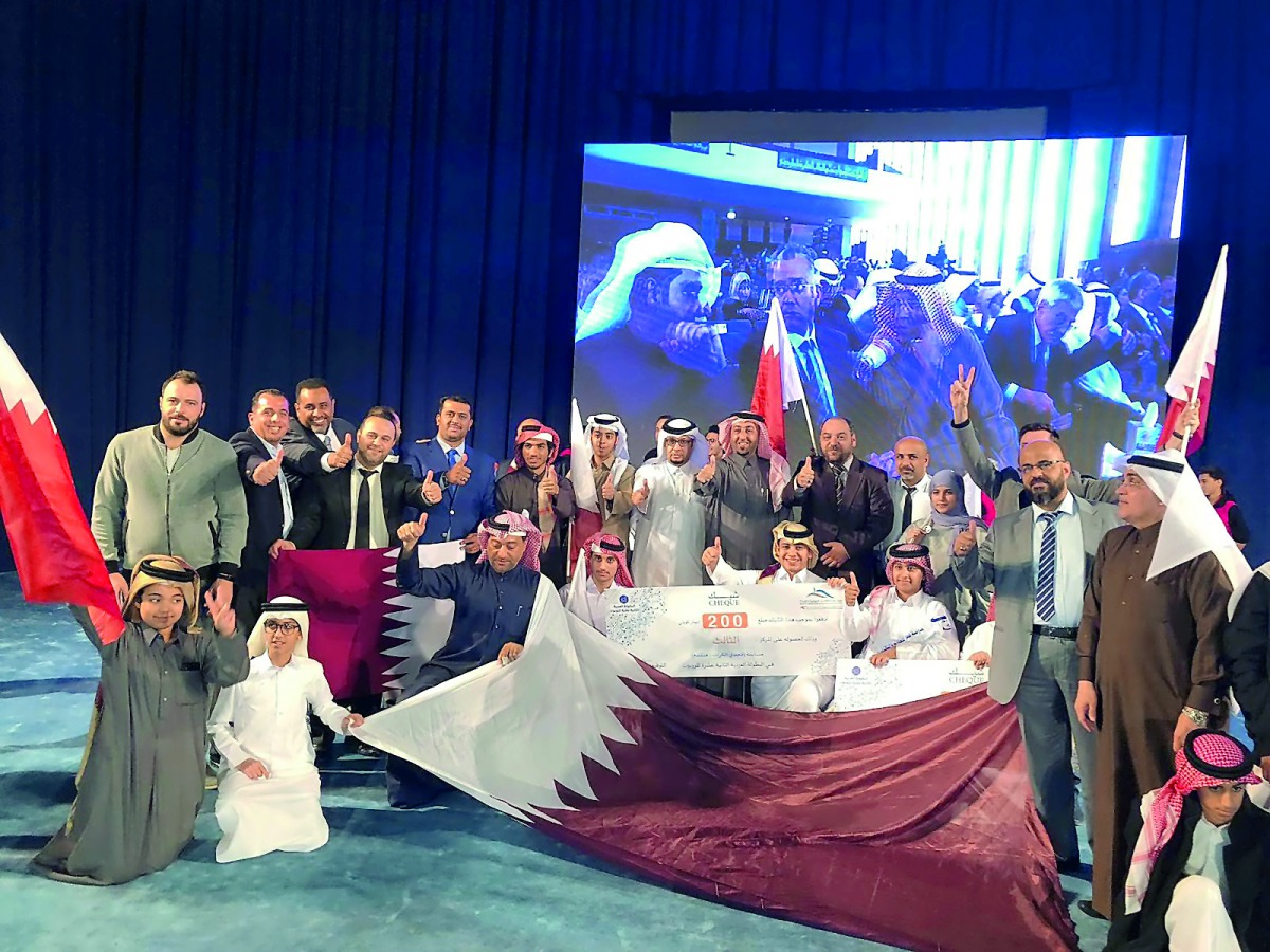 Qatari students posing for a group photo with other participants after winning positions in 12th Arab Robotics Championship in Kuwait. 