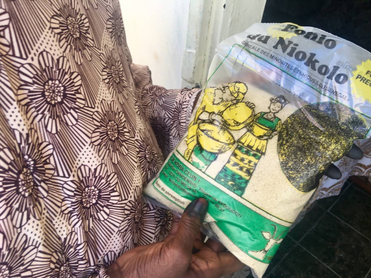 Adja Aissata Aya Ndiaye, 62, a farmer in Kedougou in southern Senegal, holds a bag of fonio she has produced, Nov. 30, 2018. Thomson Reuters Foundation/Emmanuelle Landais