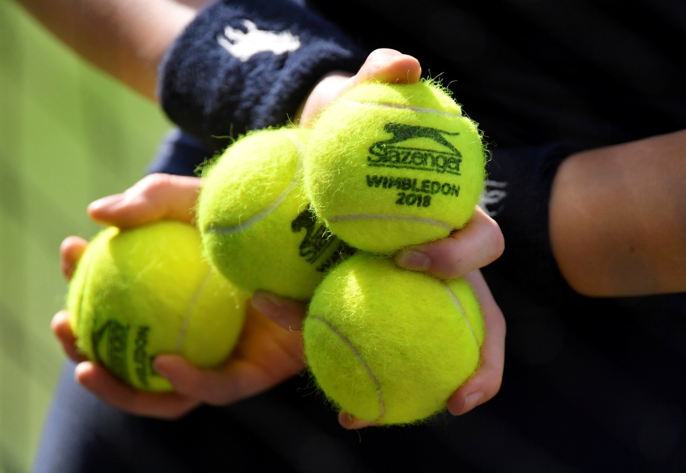 A ball boy holds balls during at Wimbledon All England Lawn Tennis and Croquet Club, London, July 9, 2018. Reuters/Toby Melville