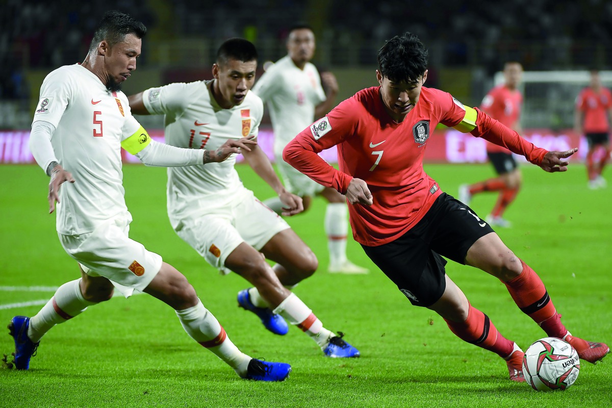 China’s defender Linpeng Zhang (left) fights for the ball with South Korea’s forward Son Heung-min during the 2019 AFC Asian Cup Group C match at the Al Nahyan Stadium in Abu Dhabi, yesterday.
