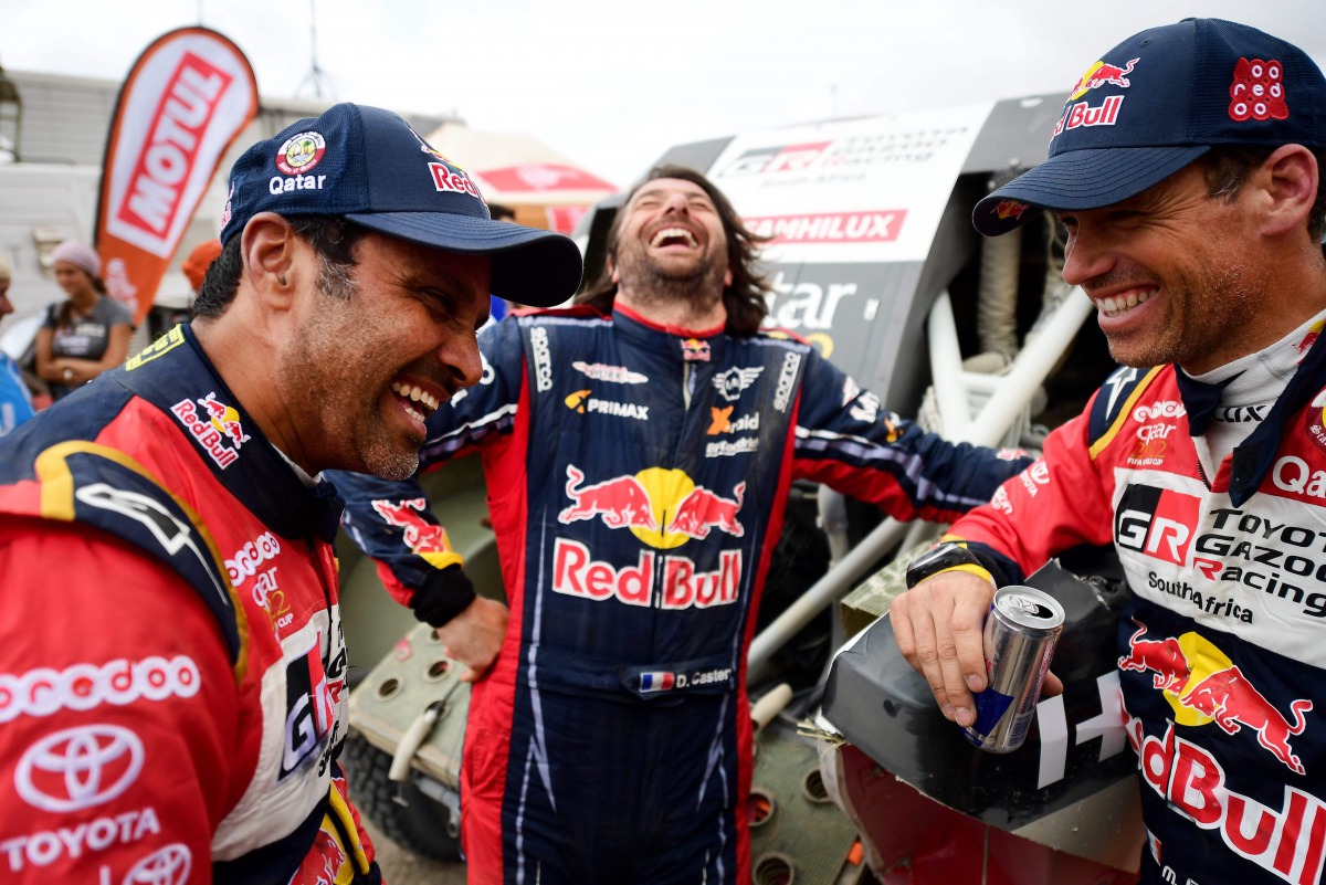 Al Attiyah (left) and his French co-driver Mathieu Baumel (right) share a light moment with Mini’s co-driver David Castera of France at the end of the Dakar Rally Stage 7 around San Juan de Marcona, in Peru.