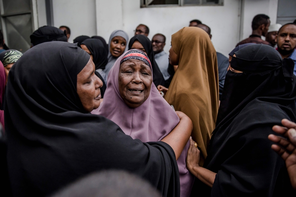 Relatives of Abdalla Mohamed Dahir who was killed the previous day in an attack react as his body arrives to the mosque during his burial ceremony in Nairobi on January 16, 2018. AFP / Luis Tato 
