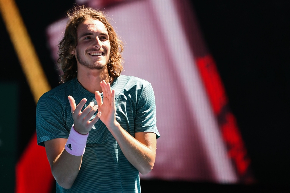 Greece's Stefanos Tsitsipas celebrates his victory against Spain's Roberto Bautista Agut during their men's singles quarter-final match on day nine of the Australian Open tennis tournament in Melbourne on January 22, 2019. AFP / William West 