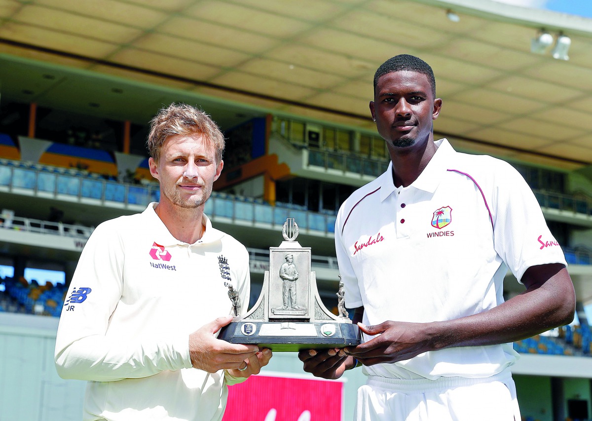 England's Joe Root and West Indies' Jason Holder pose for a photo with the trophy (Action Images via Reuters/Paul Childs) 